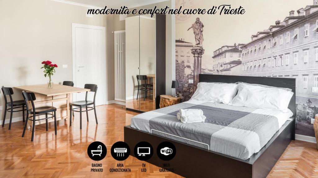 um quarto com uma cama e uma mesa com cadeiras em Garibaldino Rooms em Trieste