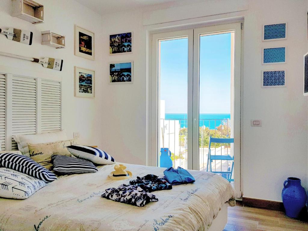 a bedroom with a bed with a view of the ocean at Polignano Vista Mare in Polignano a Mare