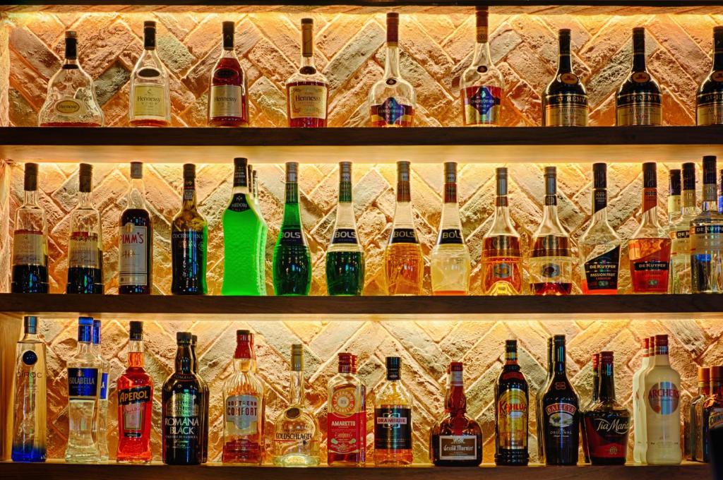 a row of bottles of alcohol on a shelf at Citymax Hotel Bur Dubai in Dubai