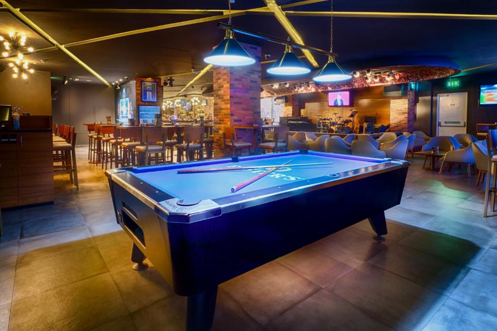 a pool table in a room with a bar at Citymax Hotel Bur Dubai in Dubai