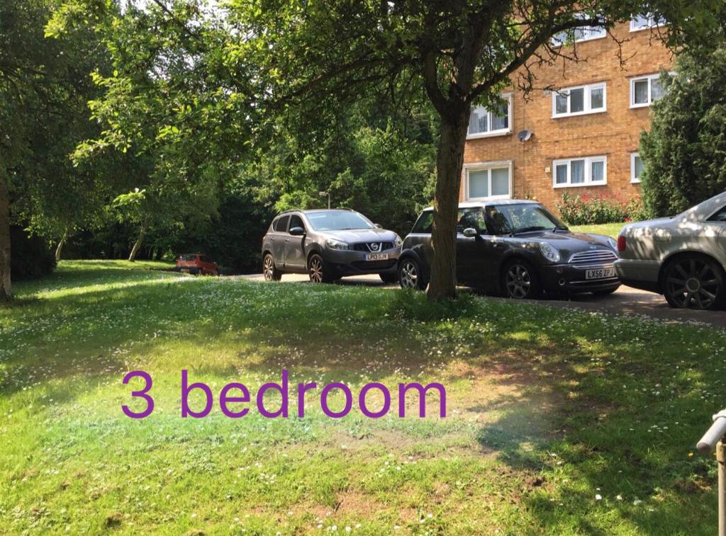 two cars parked in a yard with the words bedroom at Spacious 3 Bedroom Apartment in St. Albans