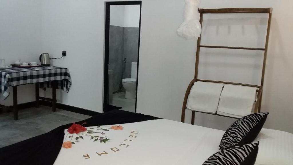 Postel nebo postele na pokoji v ubytování Sigiri Veenus Paradise