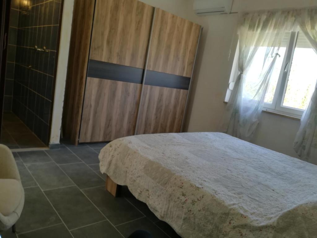 a bedroom with a large bed and a window at Guesthouse Porec in Poreč