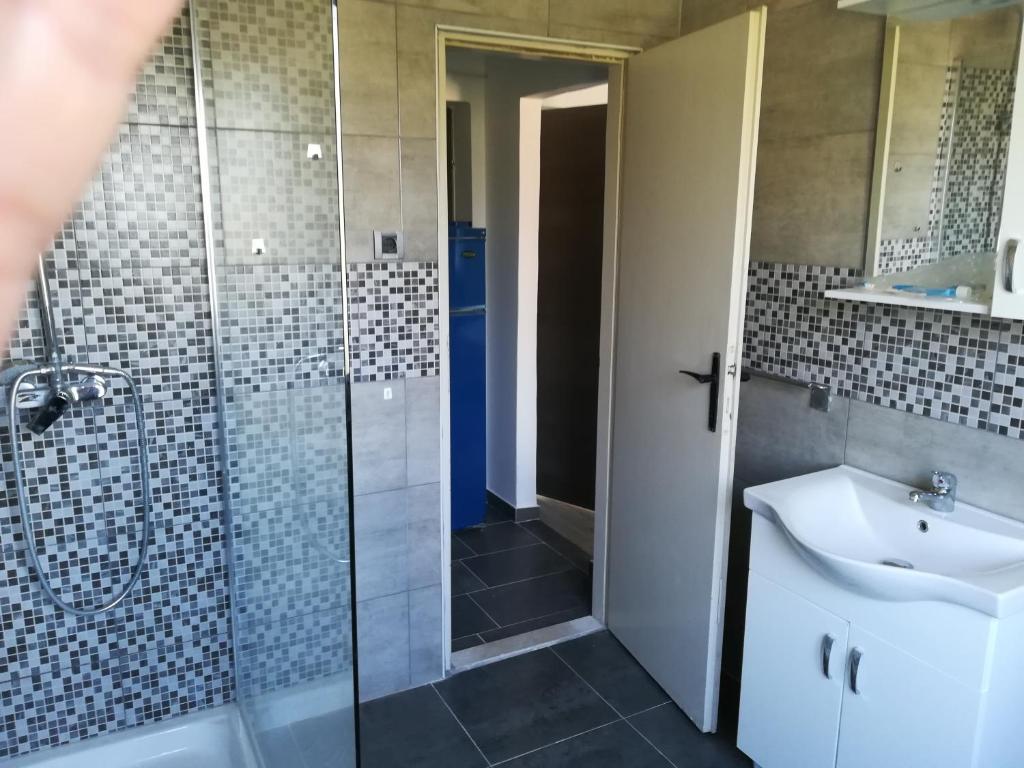 a bathroom with a shower and a sink and a toilet at Guesthouse Porec in Poreč
