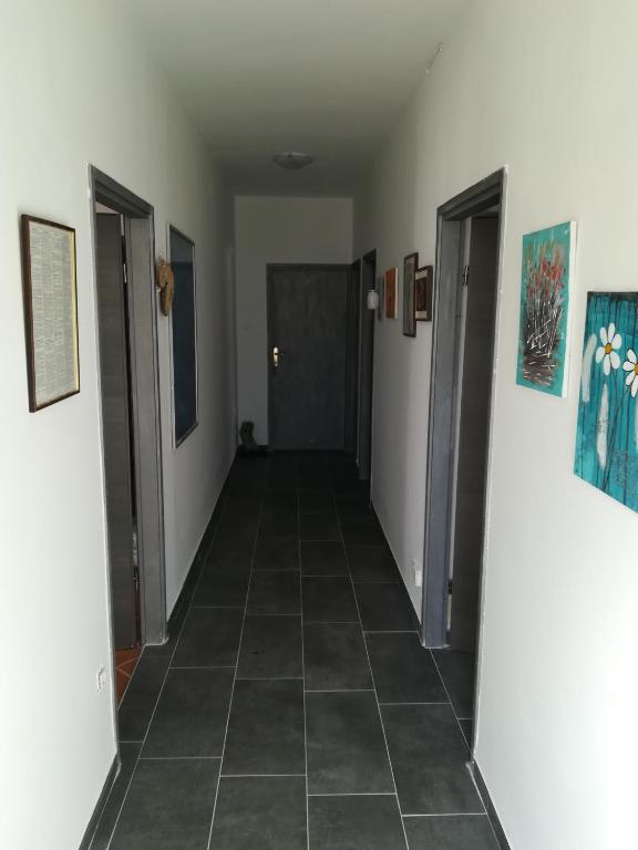 a hallway with two doors and a tile floor at Guesthouse Porec in Poreč