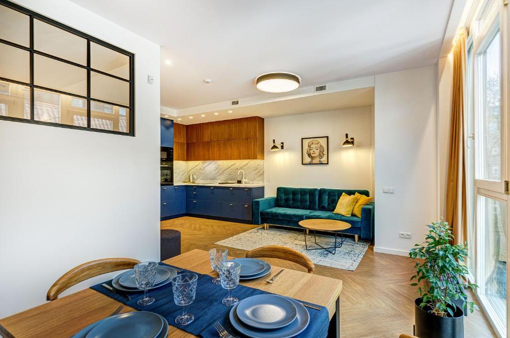 a dining room and living room with a table and chairs at Downtown apartment in Vilnius str. in Vilnius