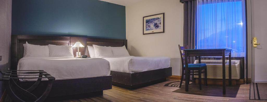 Postel nebo postele na pokoji v ubytování Hotel Le Montagnais