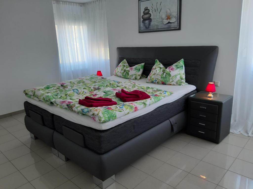 1 dormitorio con 1 cama grande con almohadas rojas en Loft Orchidee 2 en Überlingen