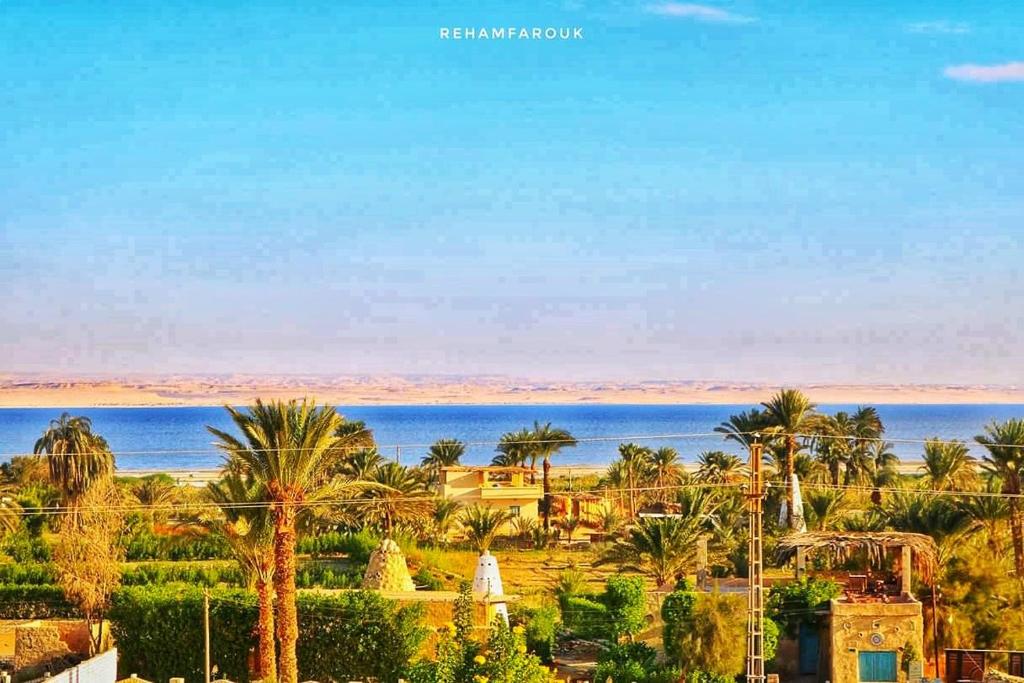 a view of a resort with palm trees and the ocean at Tunis Village Chalet in Fayoum Center