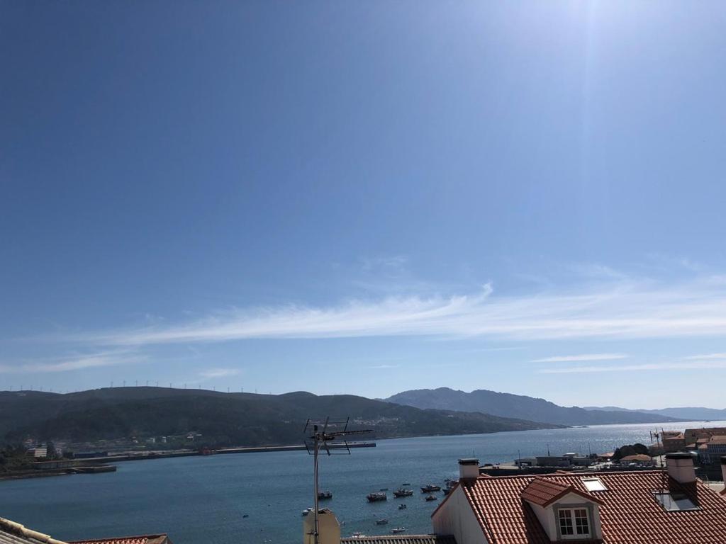 a view of a body of water with boats in it at Apartamentos Corcubión in Corcubión