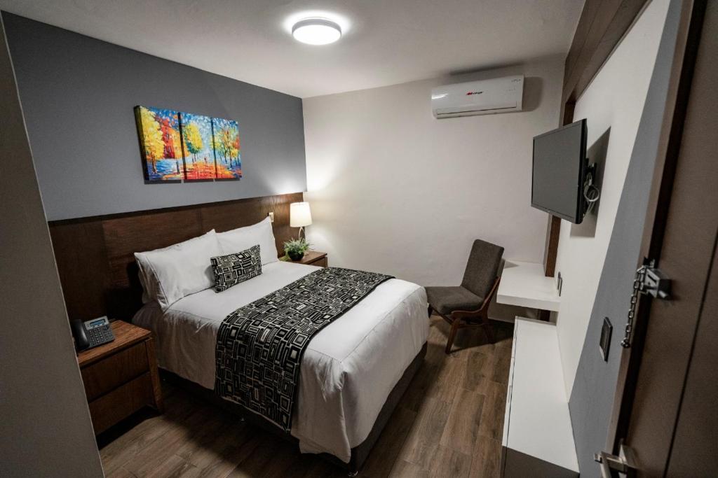 Postel nebo postele na pokoji v ubytování Hotel Corral Grande