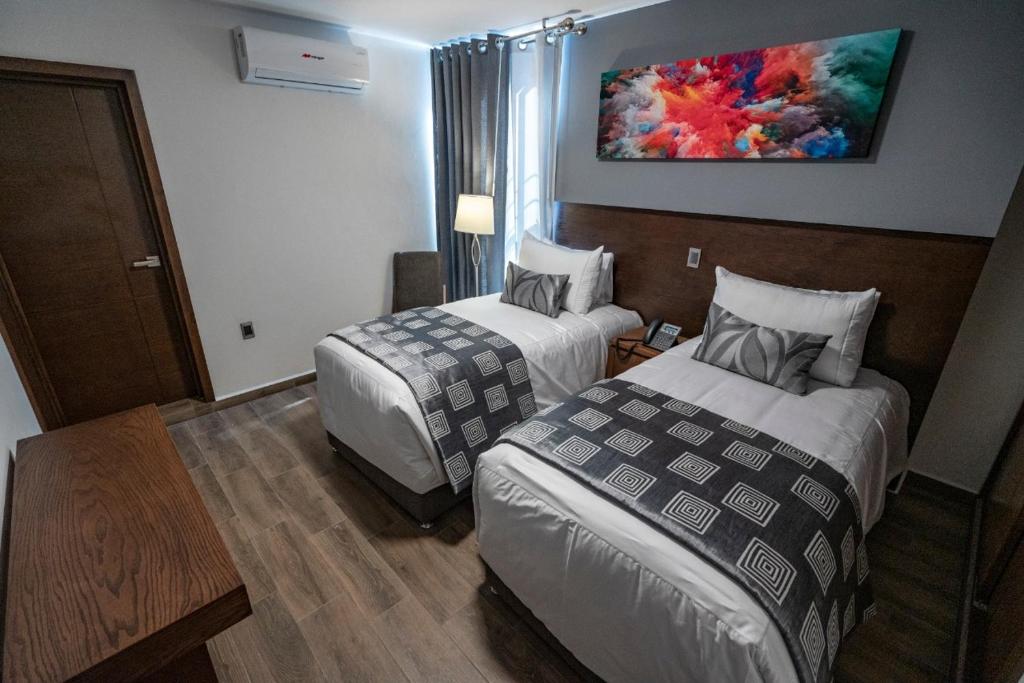 Postel nebo postele na pokoji v ubytování Hotel Corral Grande
