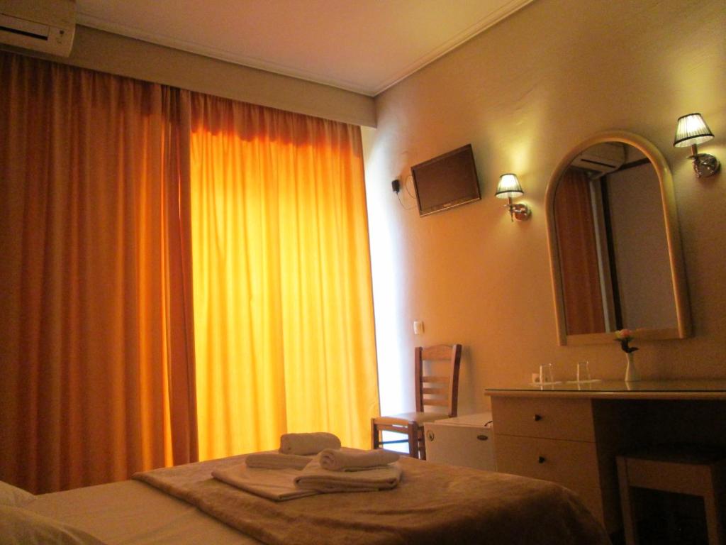 a hotel room with a bed with towels on it at Hotel Lito in Paralia Katerinis