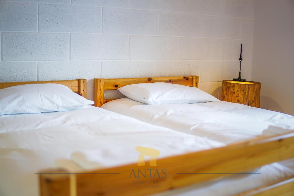 two beds sitting next to each other in a room at Antas Guest House in Esposende