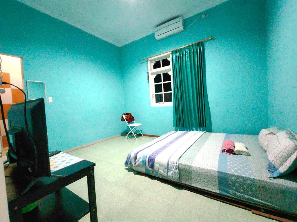 Postel nebo postele na pokoji v ubytování Mulia Homestay