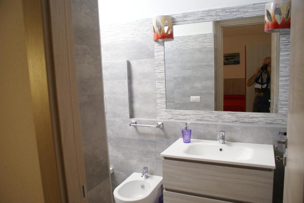 a bathroom with a sink and a mirror at casa mariolu 2 in Cala Gonone