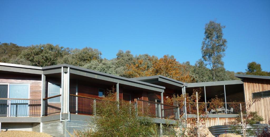 an image of a house with trees in the background at Saje's House & Pod in Myrtleford