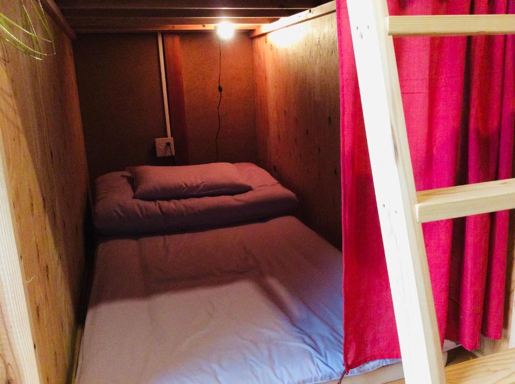 Postel nebo postele na pokoji v ubytování Kitatono Guest House