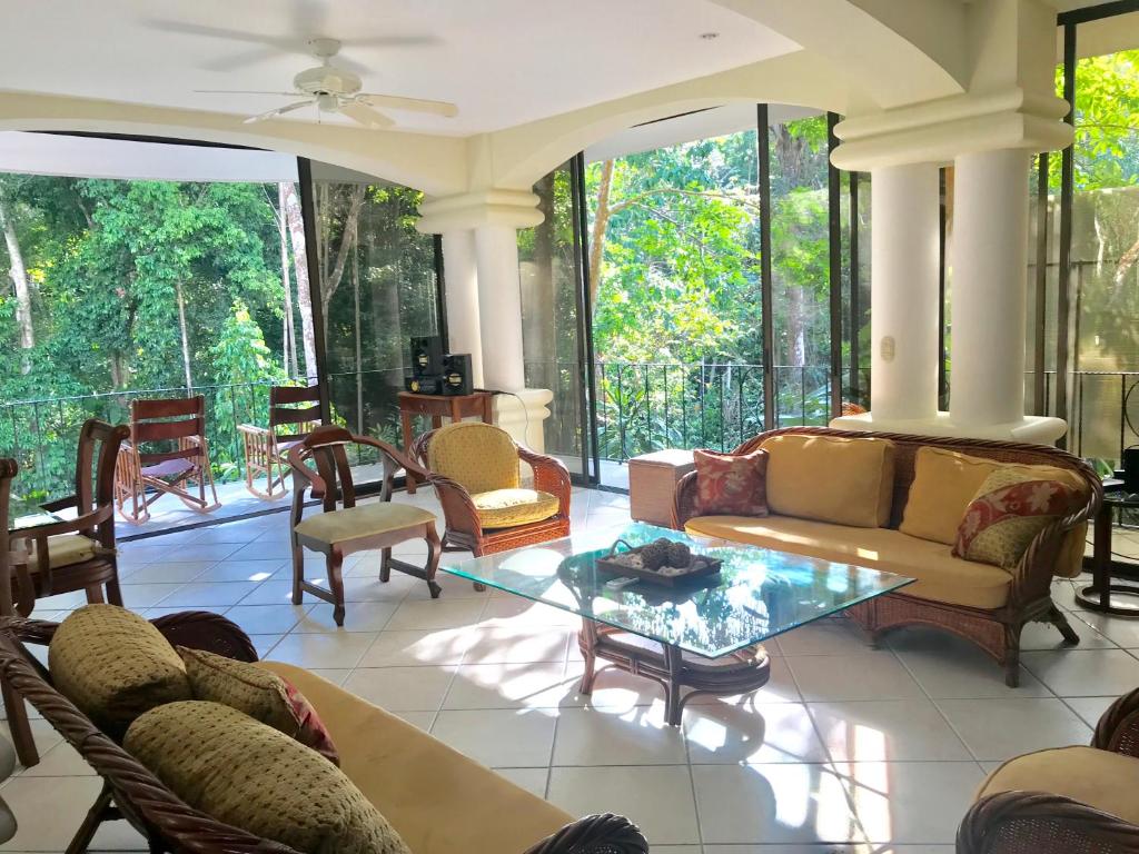 a living room with couches and chairs at Enchanted Home in Manuel Antonio