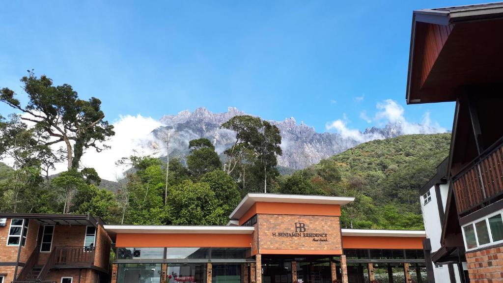 a building with a mountain in the background at H Benjamin Residence in Kundasang