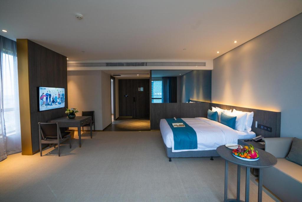 Postel nebo postele na pokoji v ubytování Hangzhou Cosy Park Hotel(Liangzhu)