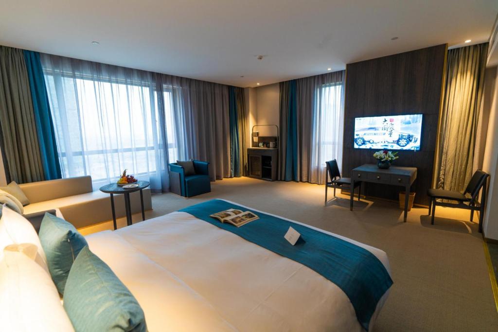 Postel nebo postele na pokoji v ubytování Hangzhou Cosy Park Hotel(Liangzhu)