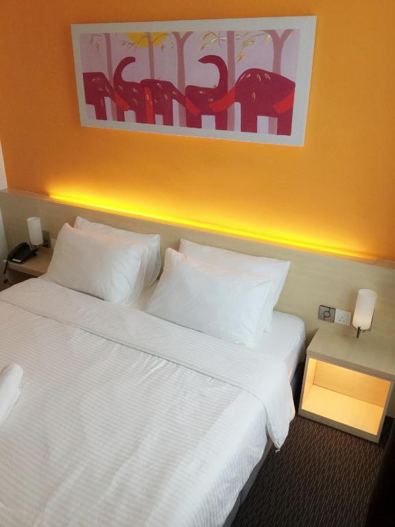 Postel nebo postele na pokoji v ubytování Hotel Jeti Tg Gemok