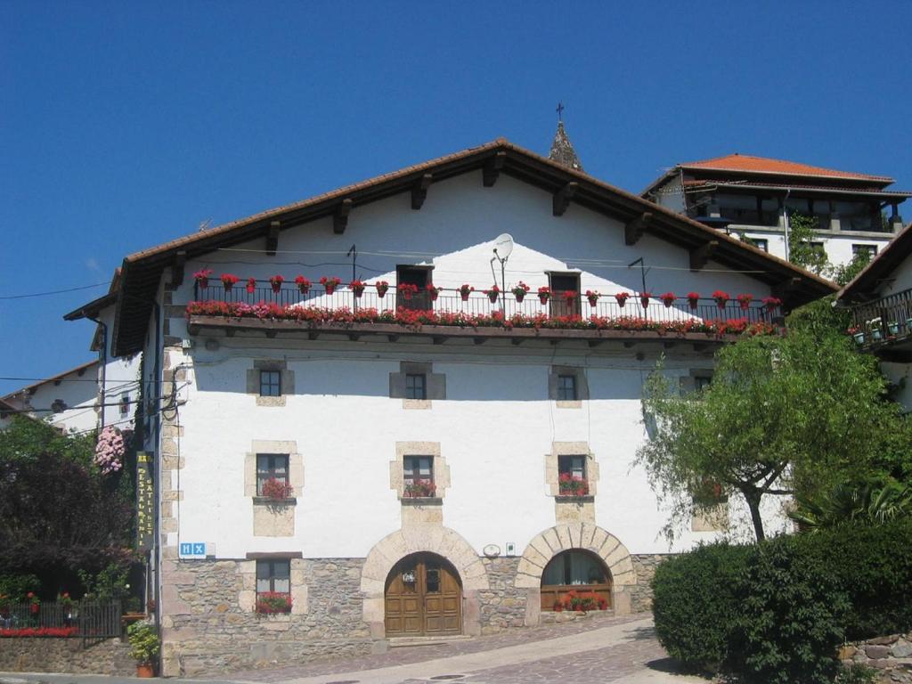 a large building with a clock on the front of it at Hostal Ezkurra in Ezkurra