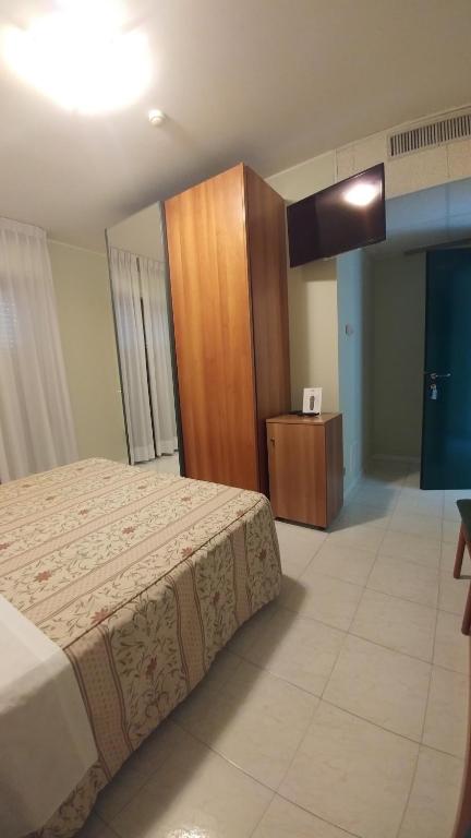 Postel nebo postele na pokoji v ubytování La Perla B&B Hotel