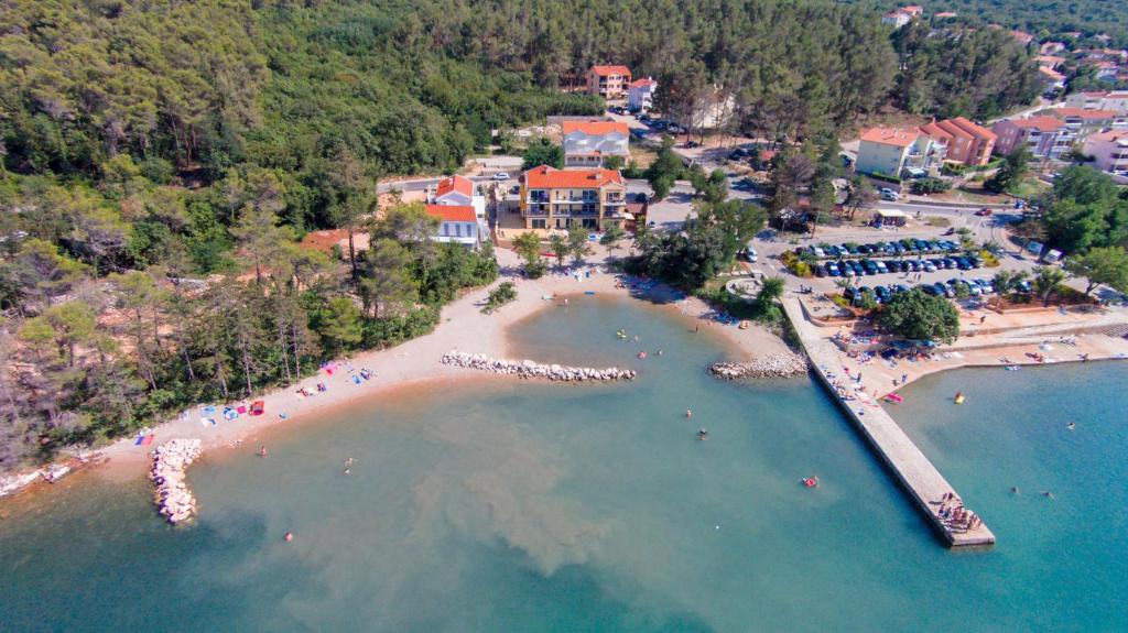 an aerial view of a beach with people in the water at Apartments Sucic Iva i Tea in Soline