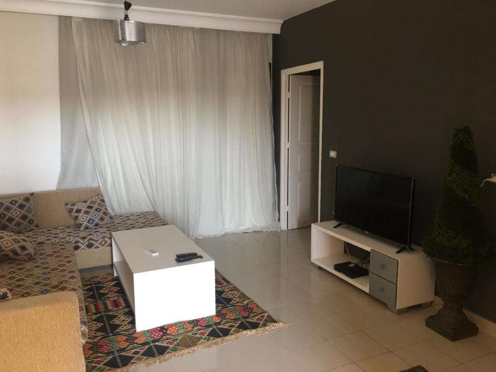 A television and/or entertainment centre at Pool View One bedroom Apt - B103