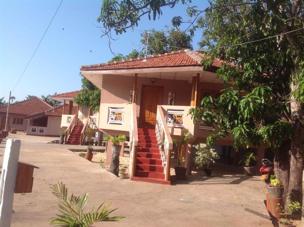 a small house with a red roof at pesalai plvillas in Pesalai