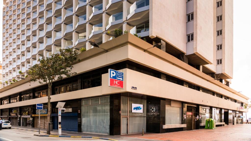 a large building with a sign in front of it at Hotel Cristina by Tigotan Las Palmas - Adults Only in Las Palmas de Gran Canaria