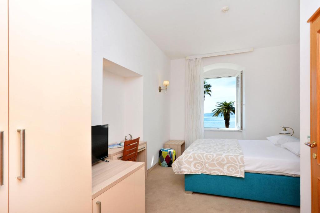 Postel nebo postele na pokoji v ubytování Hotel Adriana