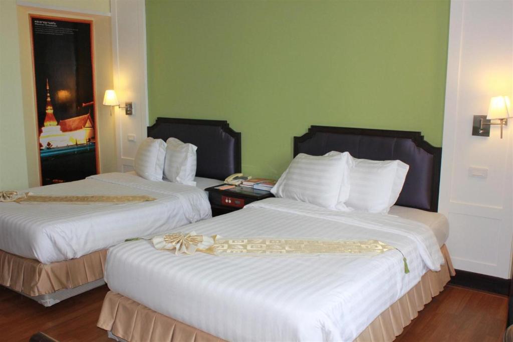 Postel nebo postele na pokoji v ubytování Charoen Thani Hotel, Khon Kaen