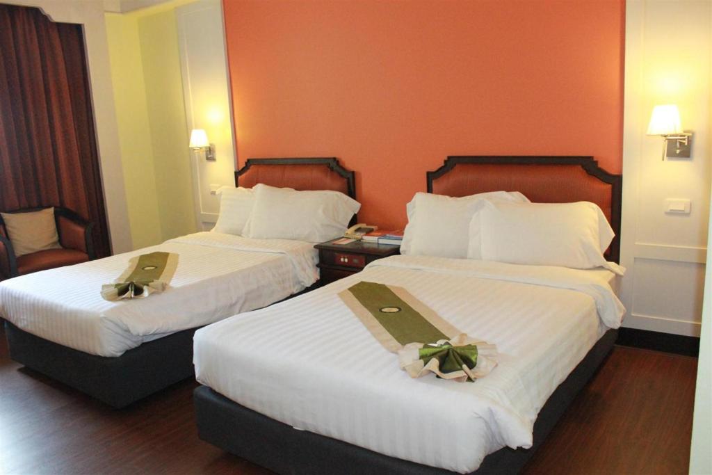 Postel nebo postele na pokoji v ubytování Charoen Thani Hotel, Khon Kaen