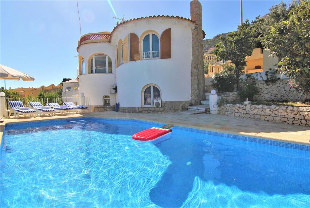 una casa con un frisbee rojo en una piscina en AMIBARCO, en Calpe