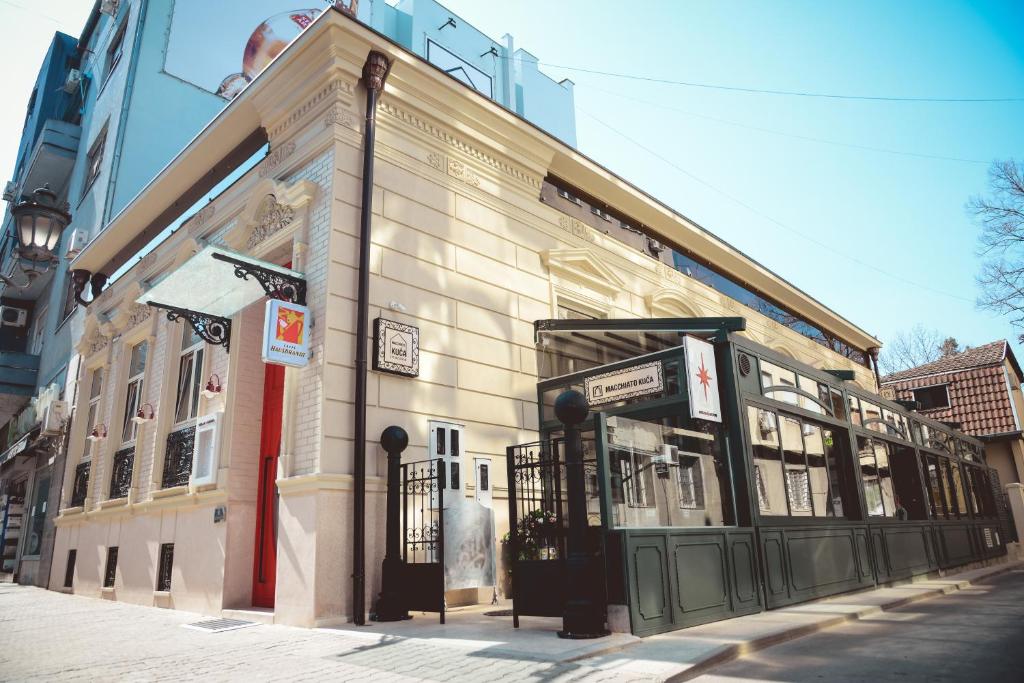 a building on the corner of a street at Boutique Macchiato House in Novi Sad