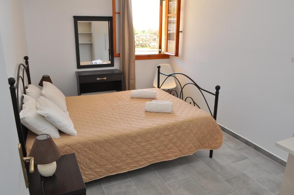 A bed or beds in a room at Polymnia Apartments Lassi