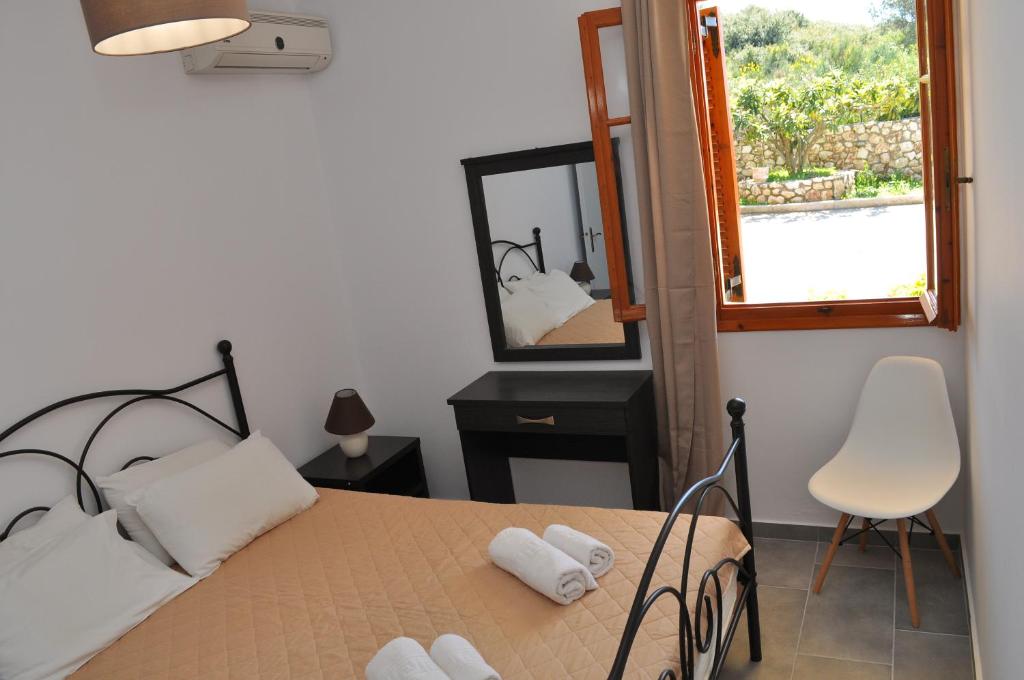 A bed or beds in a room at Polymnia Apartments Lassi