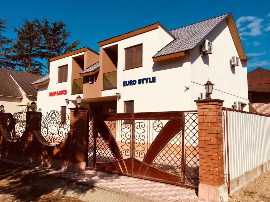 a house with a gate in front of it at Cottage Euro Style in Ureki