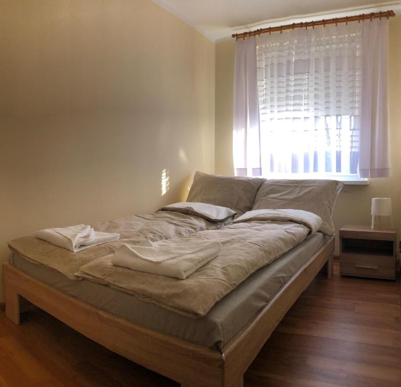 a bed sitting in a room with a window at Apartament na Zielonej parter in Kędzierzyn-Koźle