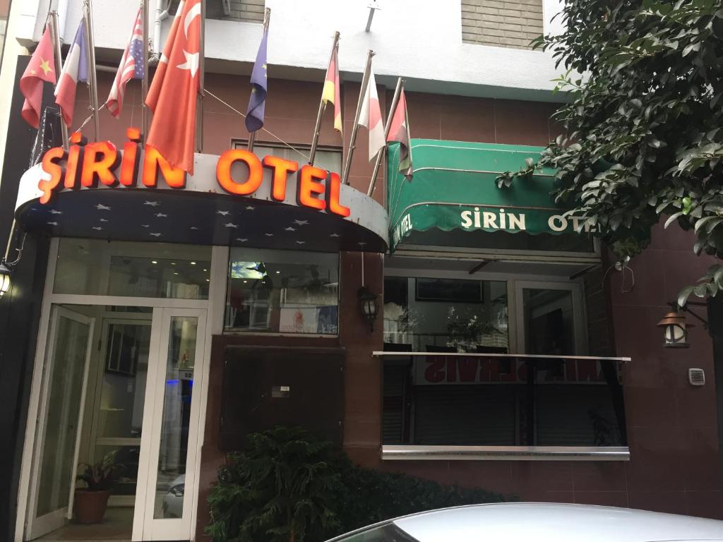 a sign for a spin off restaurant with flags in front at Şirin Hotel in Istanbul