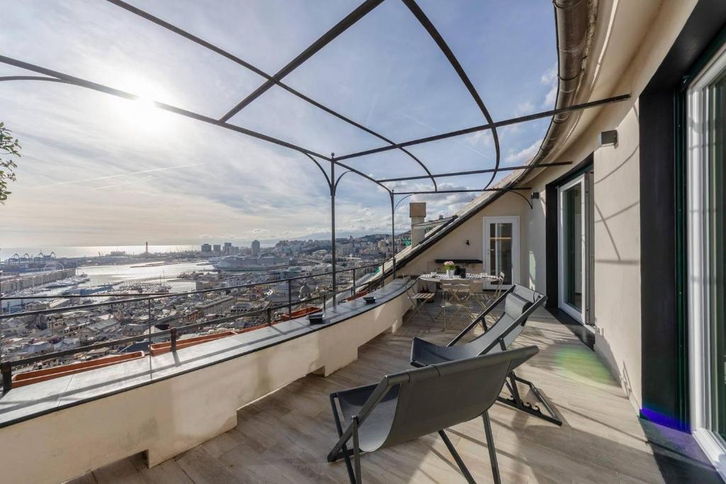 an apartment with a balcony with a view of the city at ALTIDO Exclusive Flat for 8, with Stunning City and SeaView in Genoa