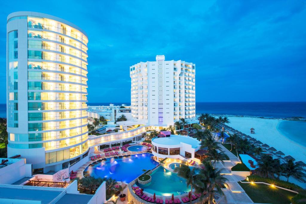 an aerial view of a resort with a pool and a building at Krystal Grand Cancun All Inclusive in Cancún