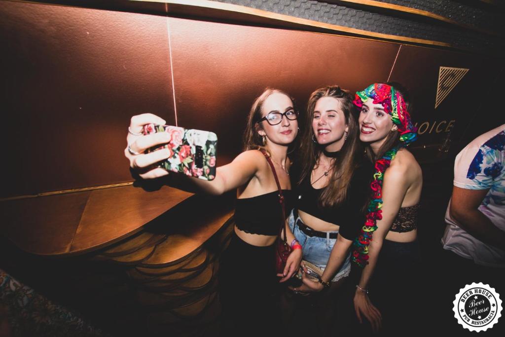 a group of girls taking a picture in a mirror at Greg&Tom Beer House Hostel in Krakow