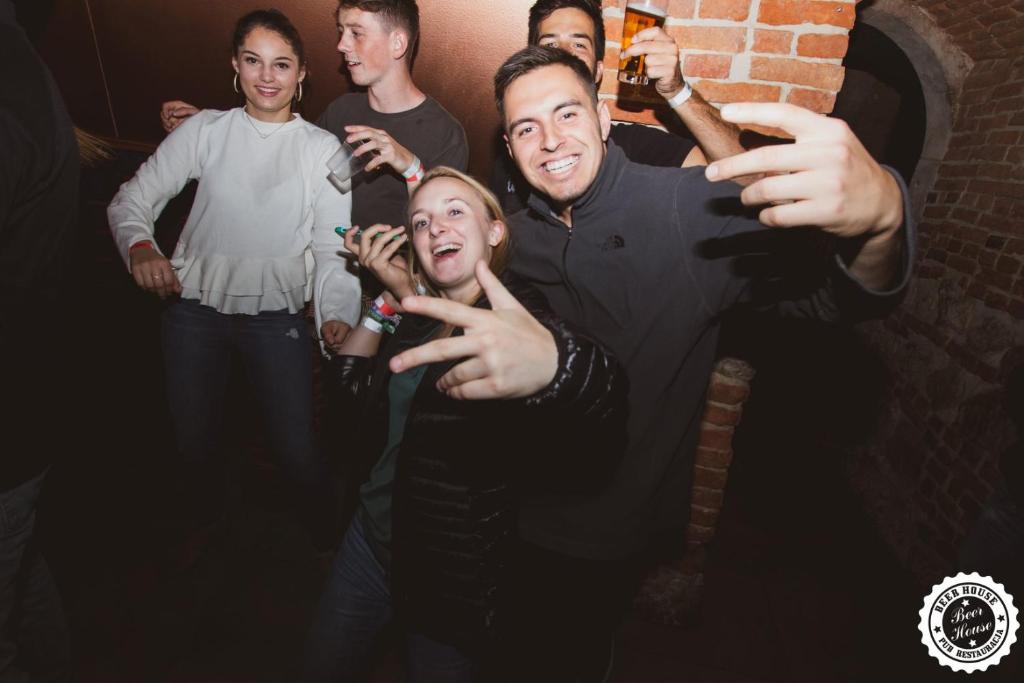 a group of people posing for a picture at Greg&Tom Beer House Hostel in Krakow