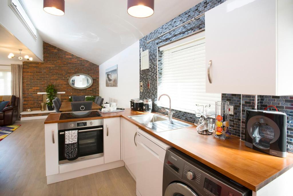 a kitchen with a sink and a counter top at Mae's Lodge in Birchington