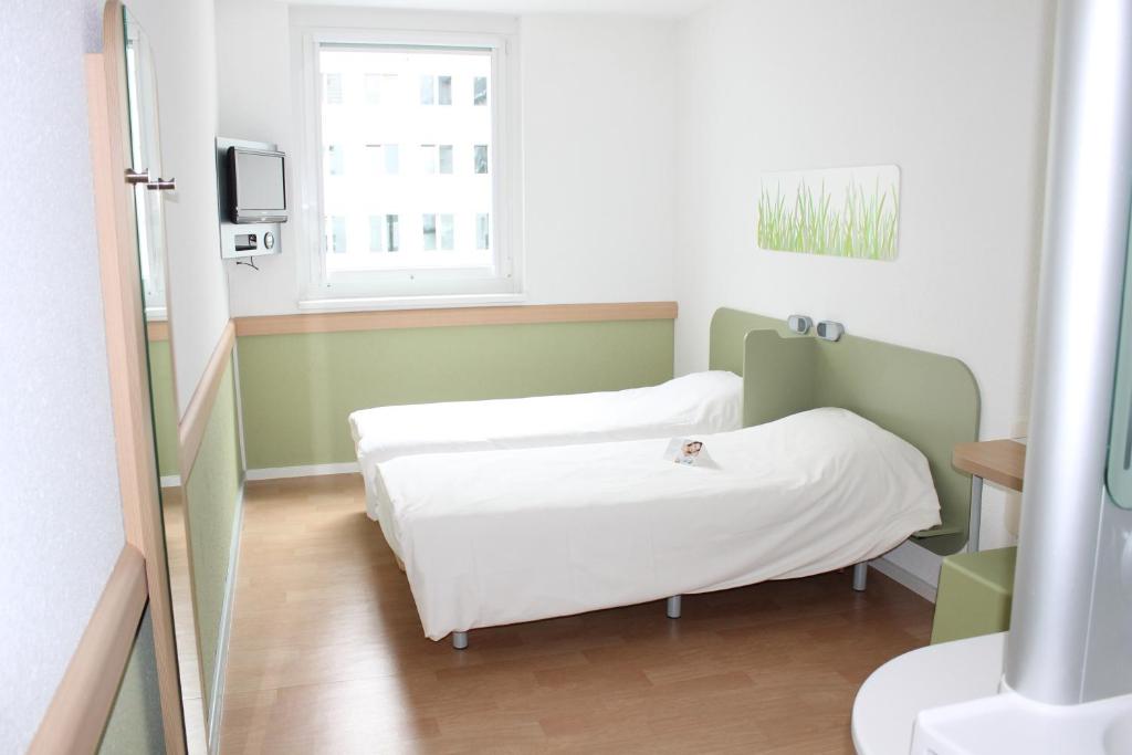 Postel nebo postele na pokoji v ubytování Ibis budget Wien Messe