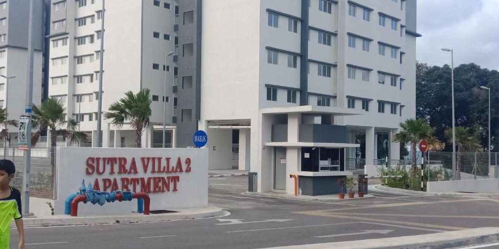 a building with a sign in front of a street at Sutravilla 2 Apartment in Kuantan